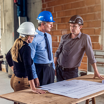 People with hard hats discussing building plans