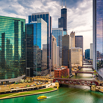 Image of high rise buildings next to a road and body of water