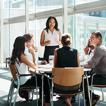 An innovative team of professionals discussing self-funding strategies at a round table