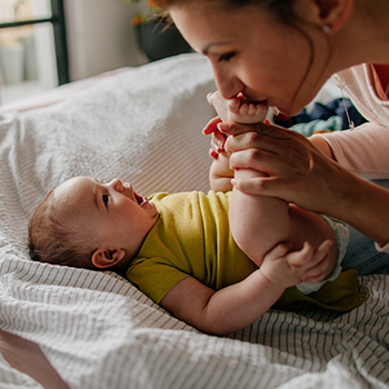 Mother kissing baby's feet