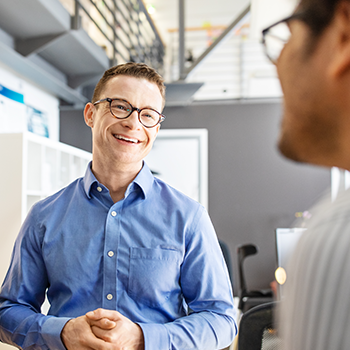 A business professional collaborating with a team member